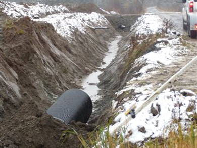 A drainage pipe is installed in the dug out trench