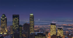 View of bridge with city skyline in foreground at night