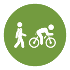 A green circle with one pictogram of a person walking and a second of a person on a bicycle