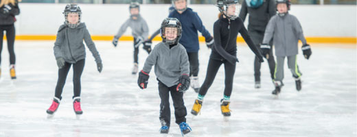 Children skating on ice rink