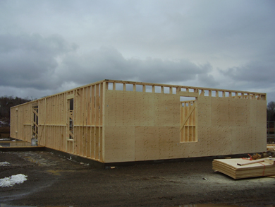 Constructing the wooden plywood frame of the new library building