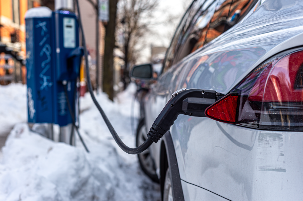 Electric car getting charged during the winter season