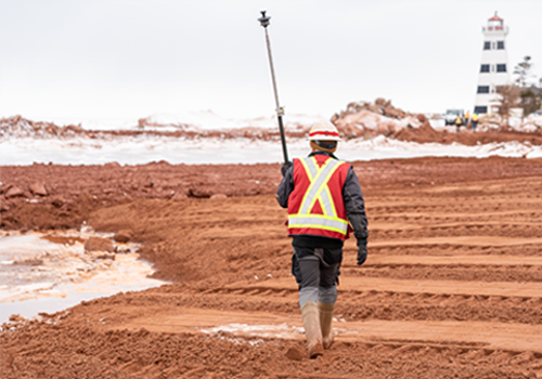 Construction worker walks on a rebuilt beach