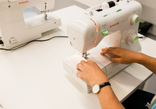 A person using a sewing machine.