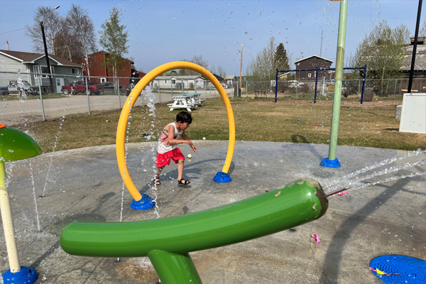 A child playing at a splash pad