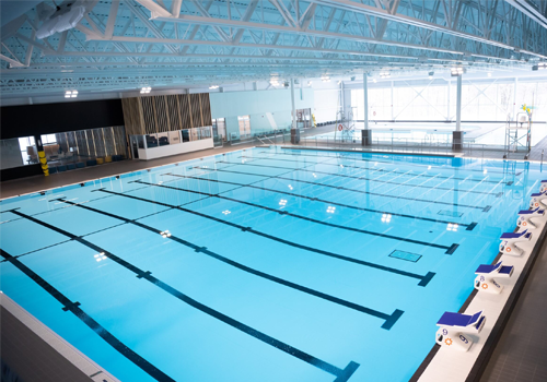 10-lane indoor pool with swimmer’s blocks alongside pool.