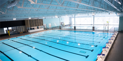 10-lane indoor pool with swimmer’s blocks alongside pool.