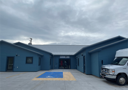 The outside entrance of a blue building.