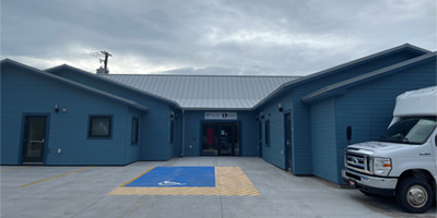 The outside entrance of a blue building.