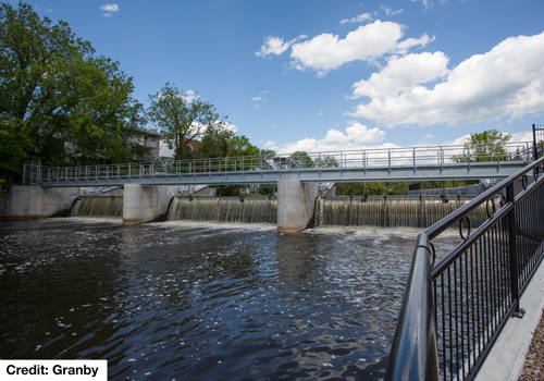 A dam next to a walking path.