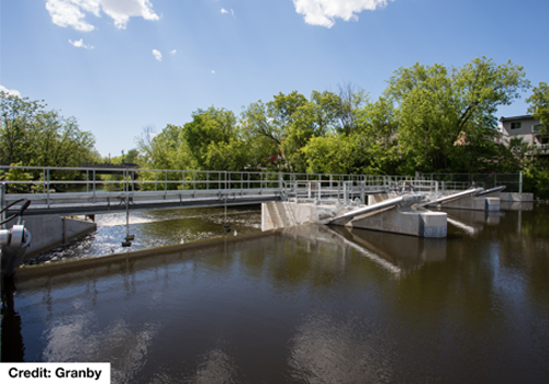 A dam with trees in the background.