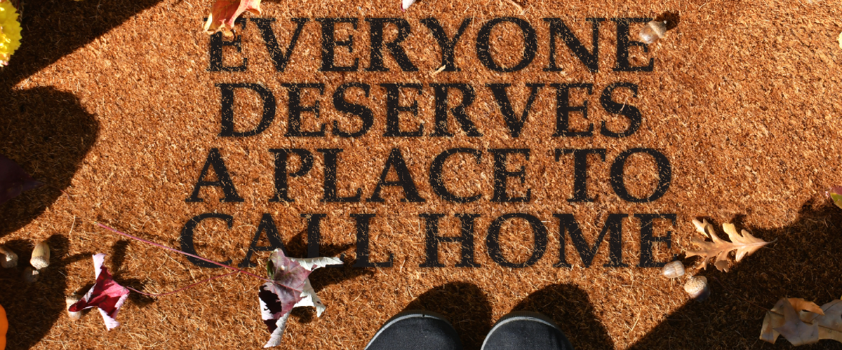 Everyone deserves a place to call home written on a doormat.