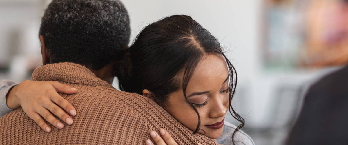 Two people hugging.