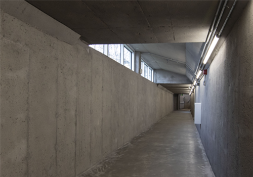 A stairwell leading out of an underground tunnel towards a building. 