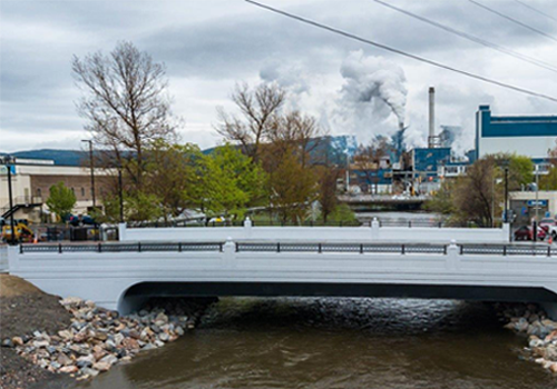 A bridge over a river with rocky banks.