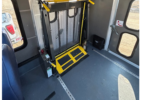 A wheelchair lift inside of a bus.